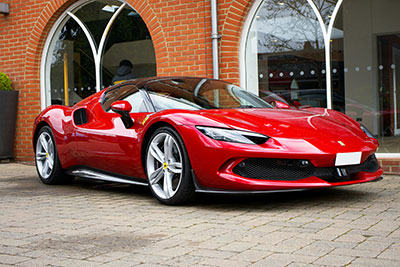 JTH Transport Image of a Ferrari outside of a showroom in the New Forest.